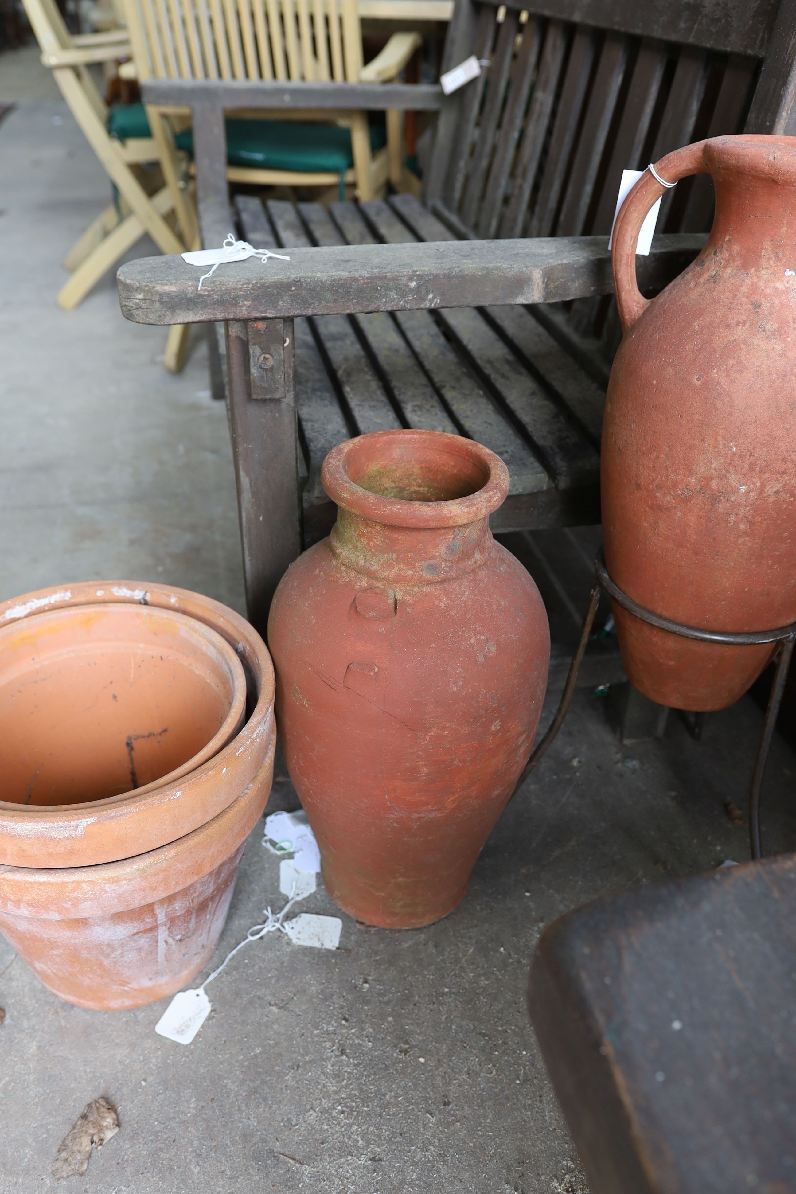 Two Greek style terracotta garden urns, one with iron stand, together with twelve assorted terracotta garden planters